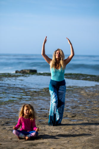 DSCF7970 Jaime McFaden and daughter on beach with Jaime's arms raised for self care