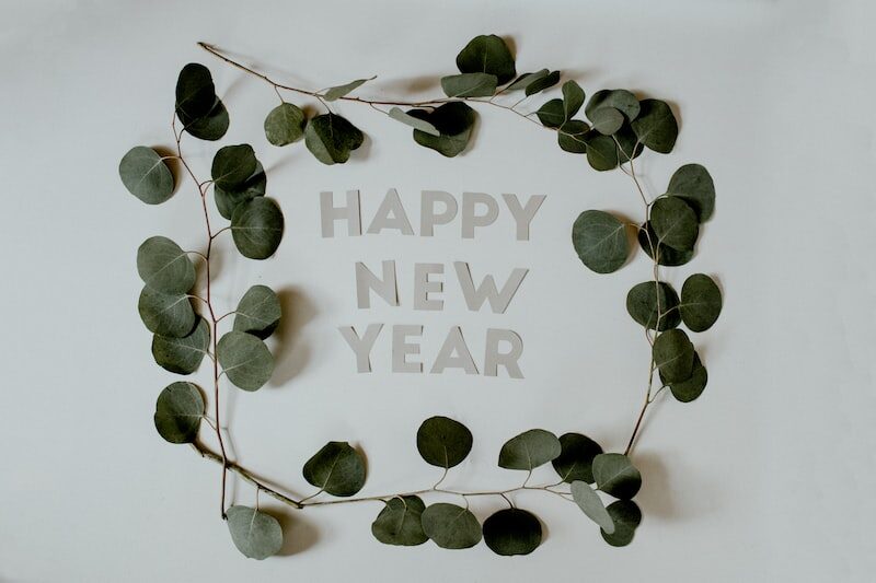 photo-1577046823799-58b2d217d508 Happy New Year 2023 petals around text